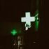 How to thrive on night shifts in a dim hospital with neon green plus sign Hospital at night with neon green plus sign glowing in dark