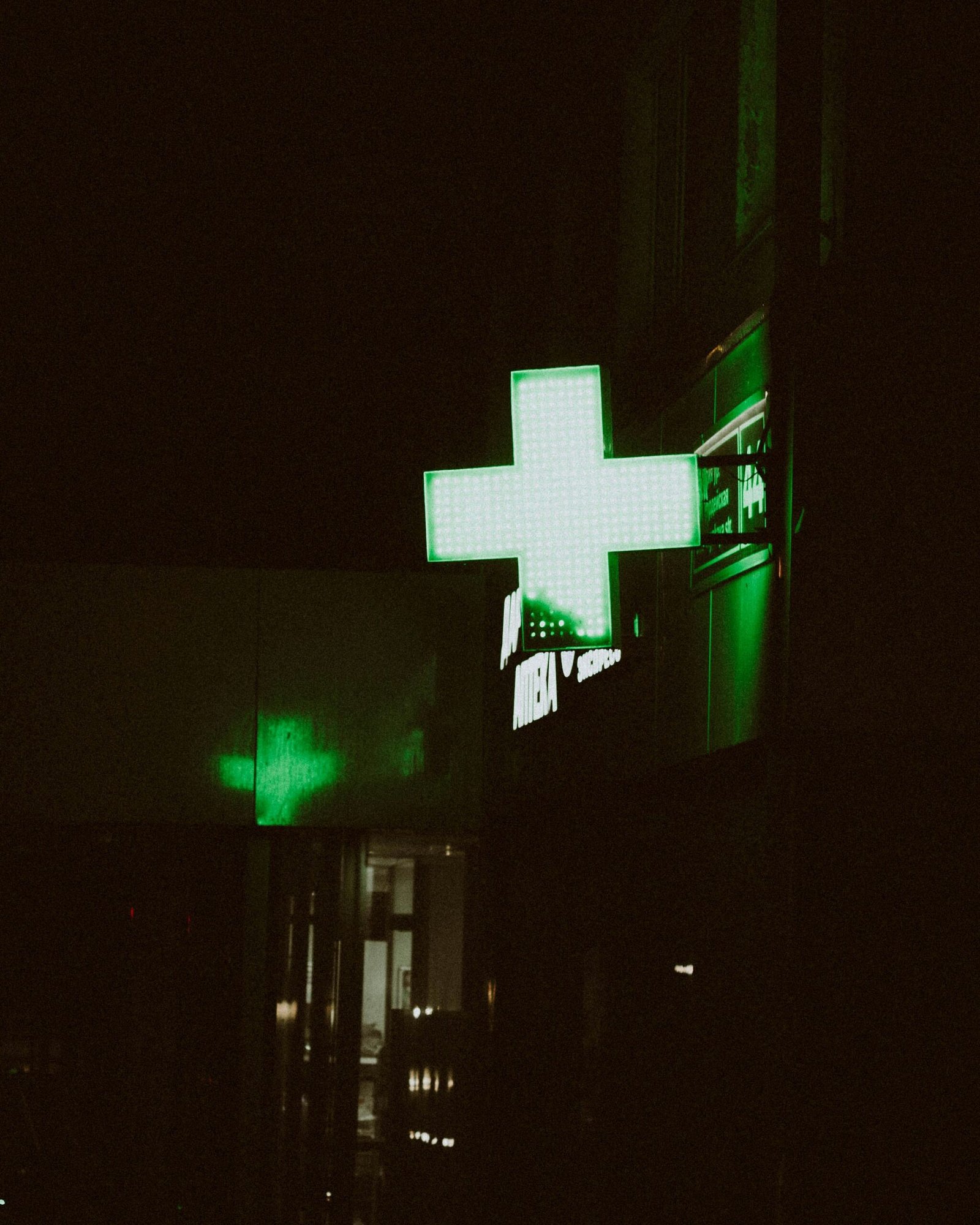 How to thrive on night shifts in a dim hospital with neon green plus sign Hospital at night with neon green plus sign glowing in dark