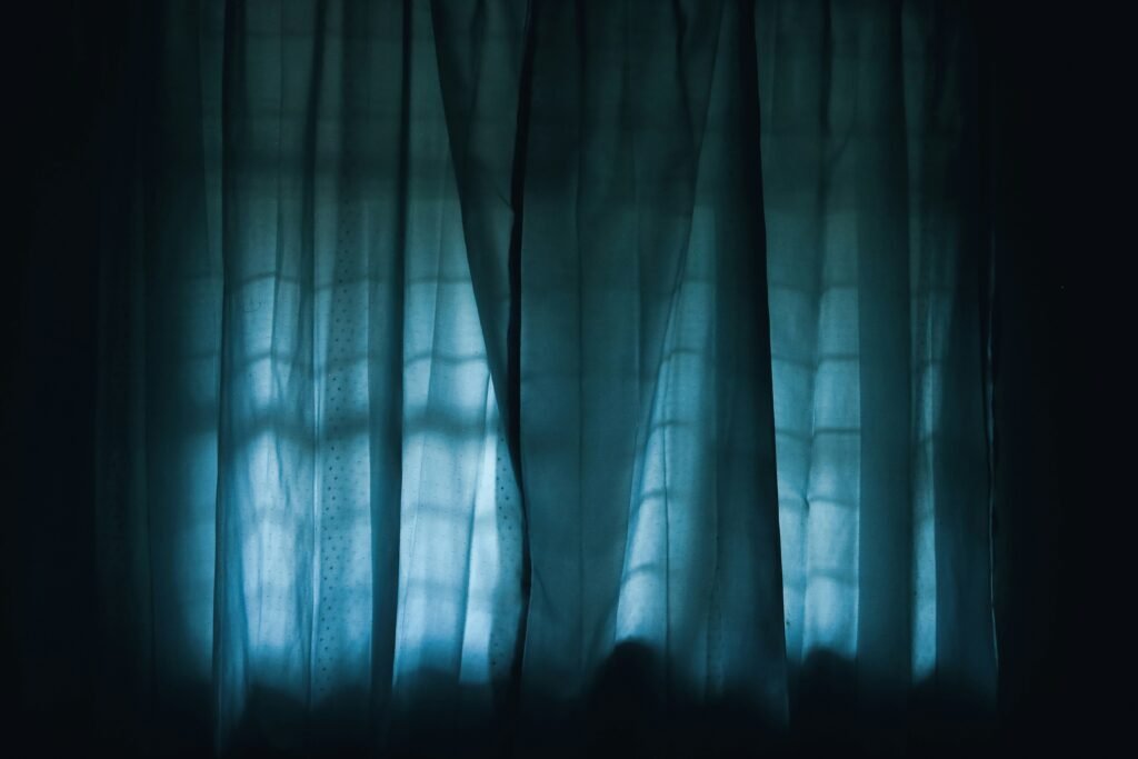 Blackout curtains blocking morning light to help thrive on night shifts