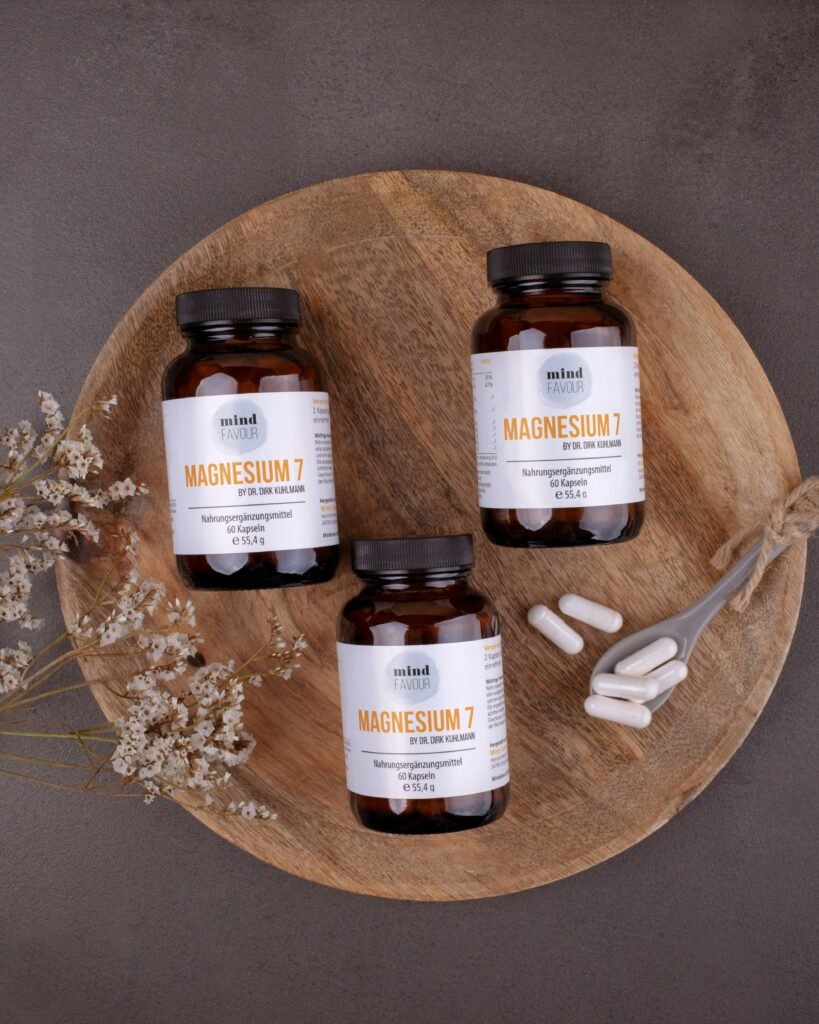 Magnesium capsules for deficiency support placed on a wooden board with dried flowers
