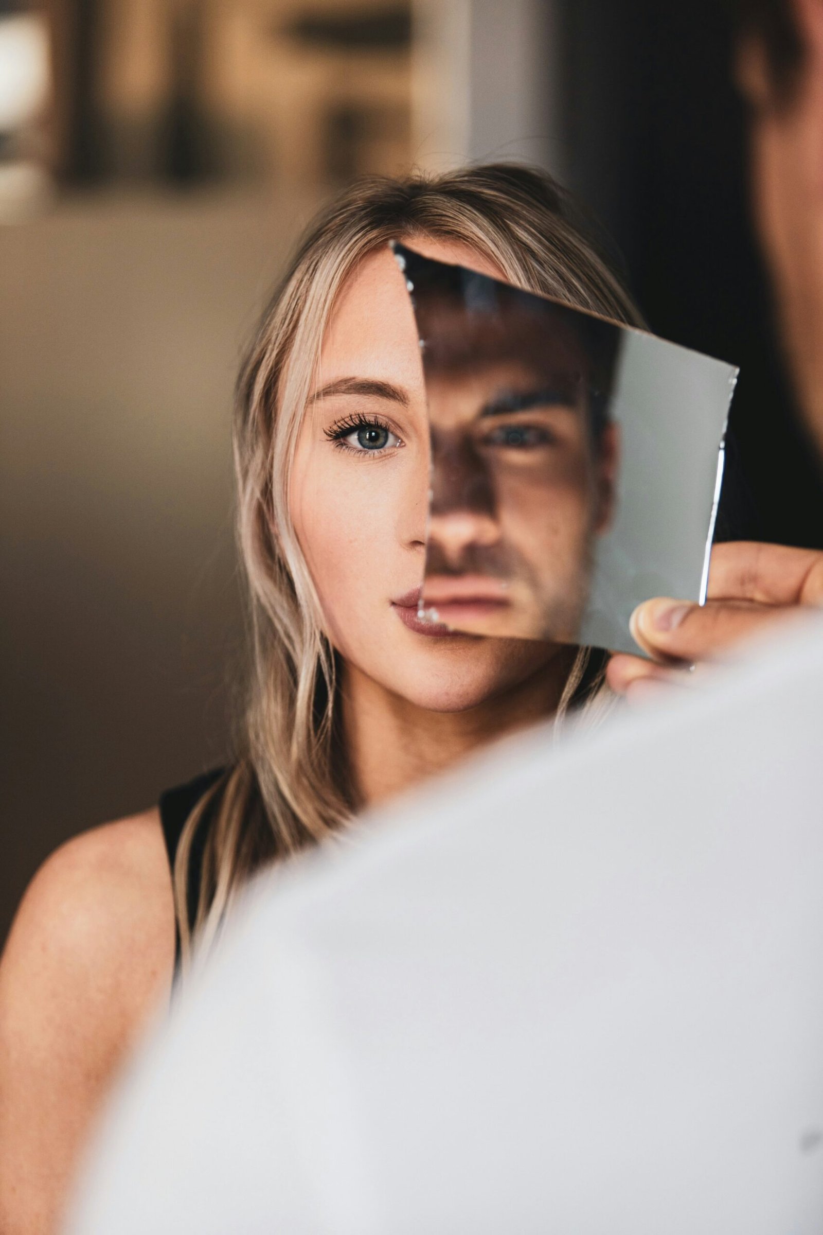 Signs of a covert narcissist in relationships symbolized by a broken mirror distorting identity.